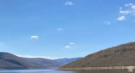 Property view of mountains featuring a water view