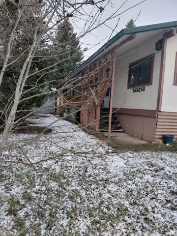 View of snow covered exterior featuring stairway
