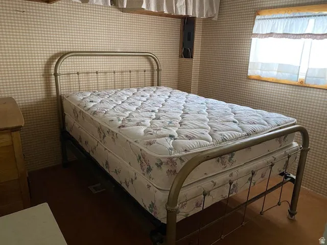 Bedroom with wallpapered walls