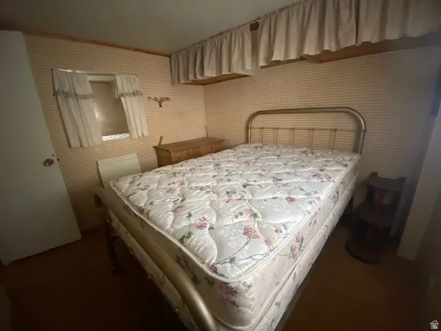 Bedroom featuring wallpapered walls