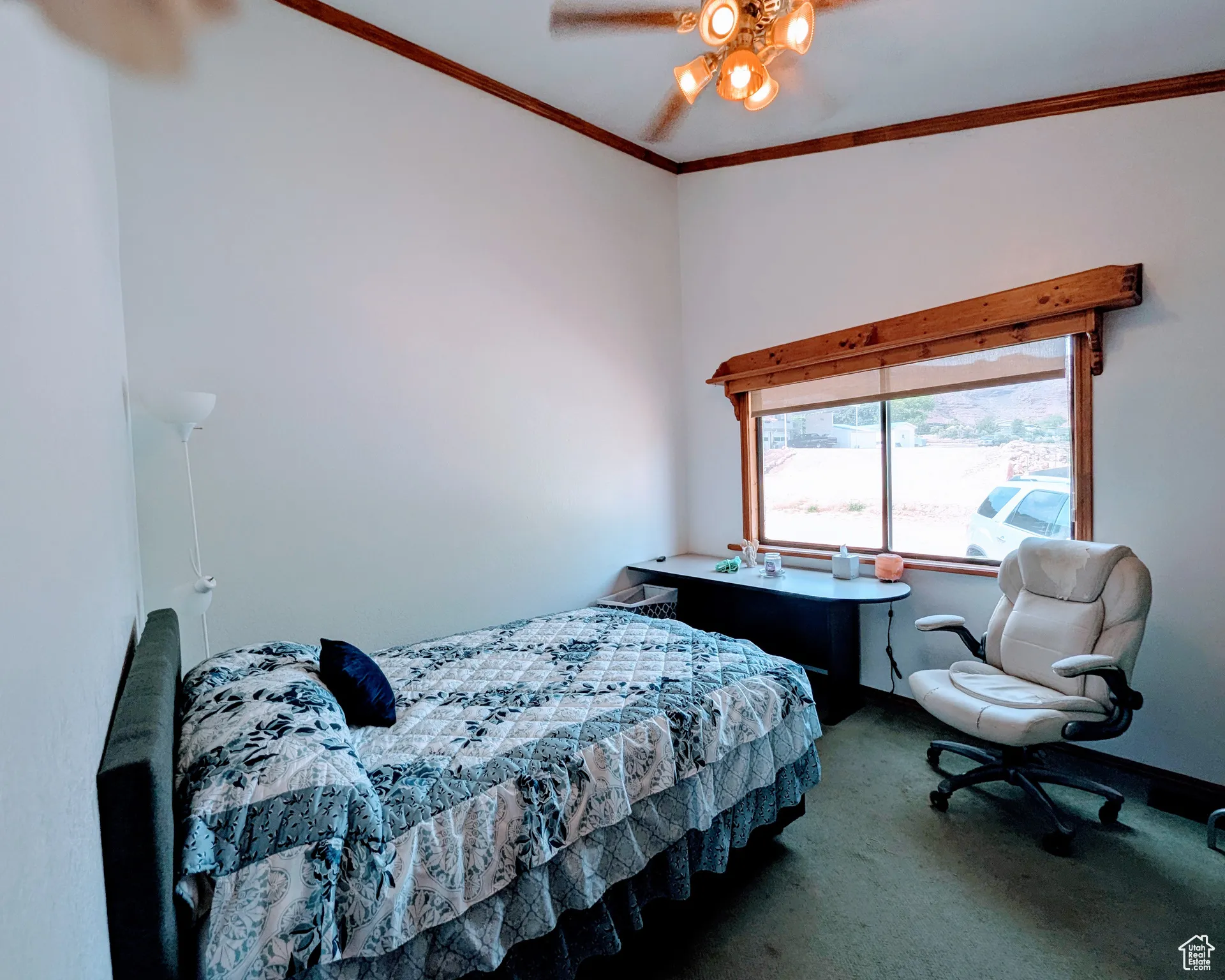 Bedroom with a ceiling fan, baseboards, ornamental molding, and carpet