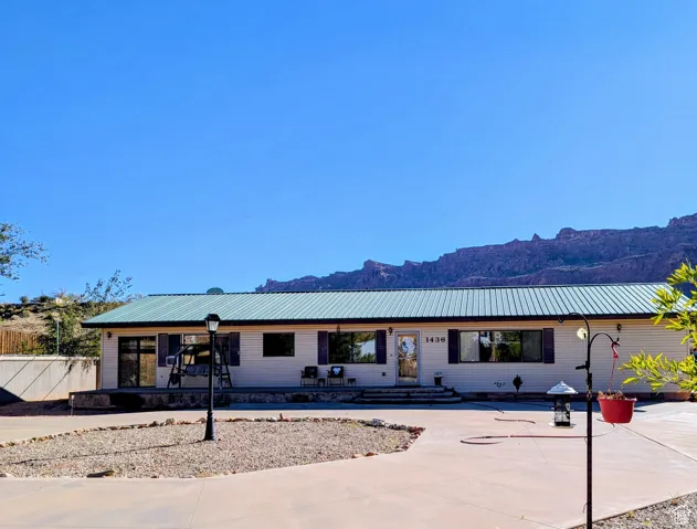 Single story home featuring a mountain view and a metal roof
