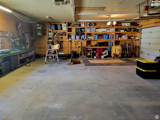 Garage with a workshop area and visible vents
