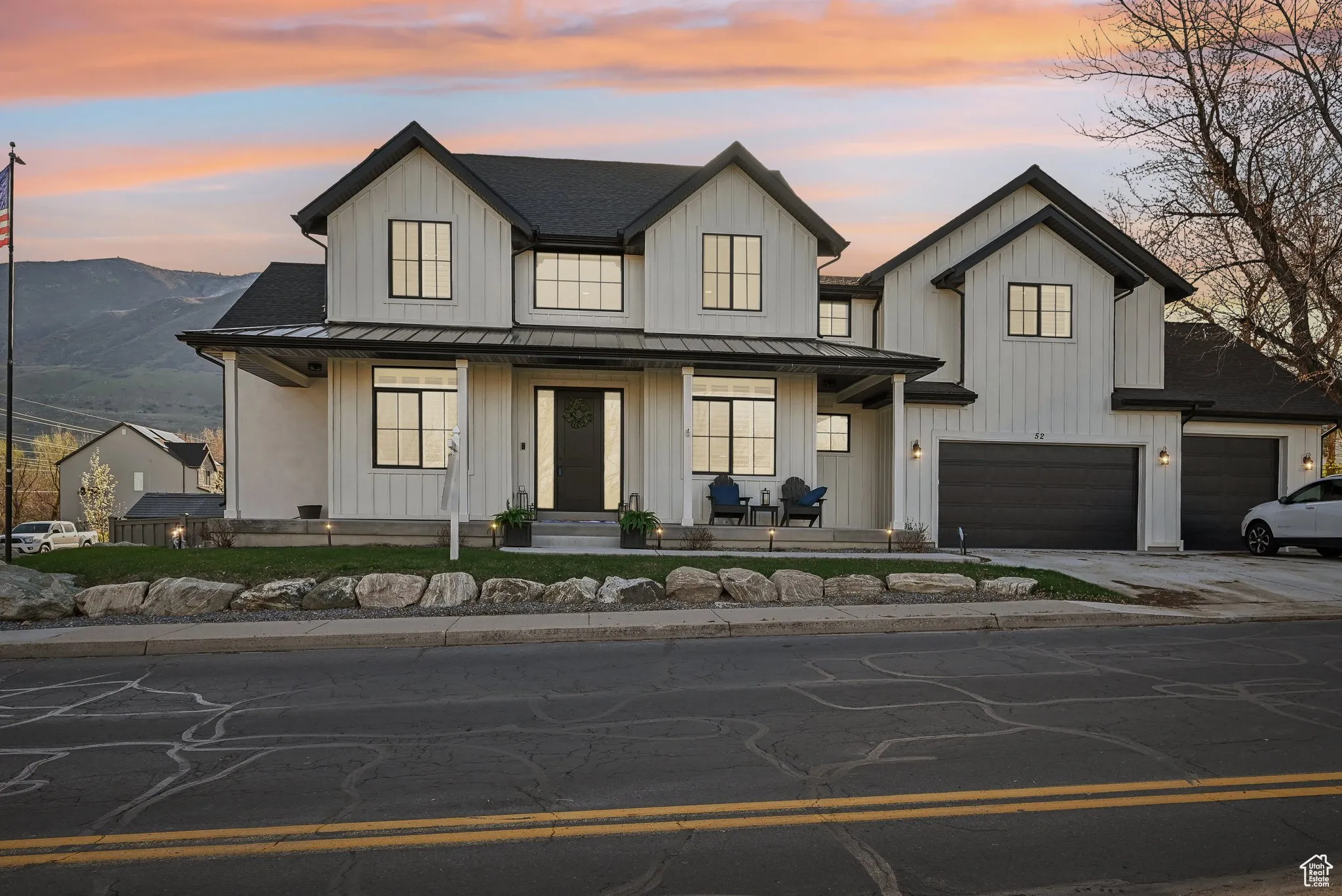 Modern farmhouse featuring a standing seam roof, metal roof, and board and batten siding