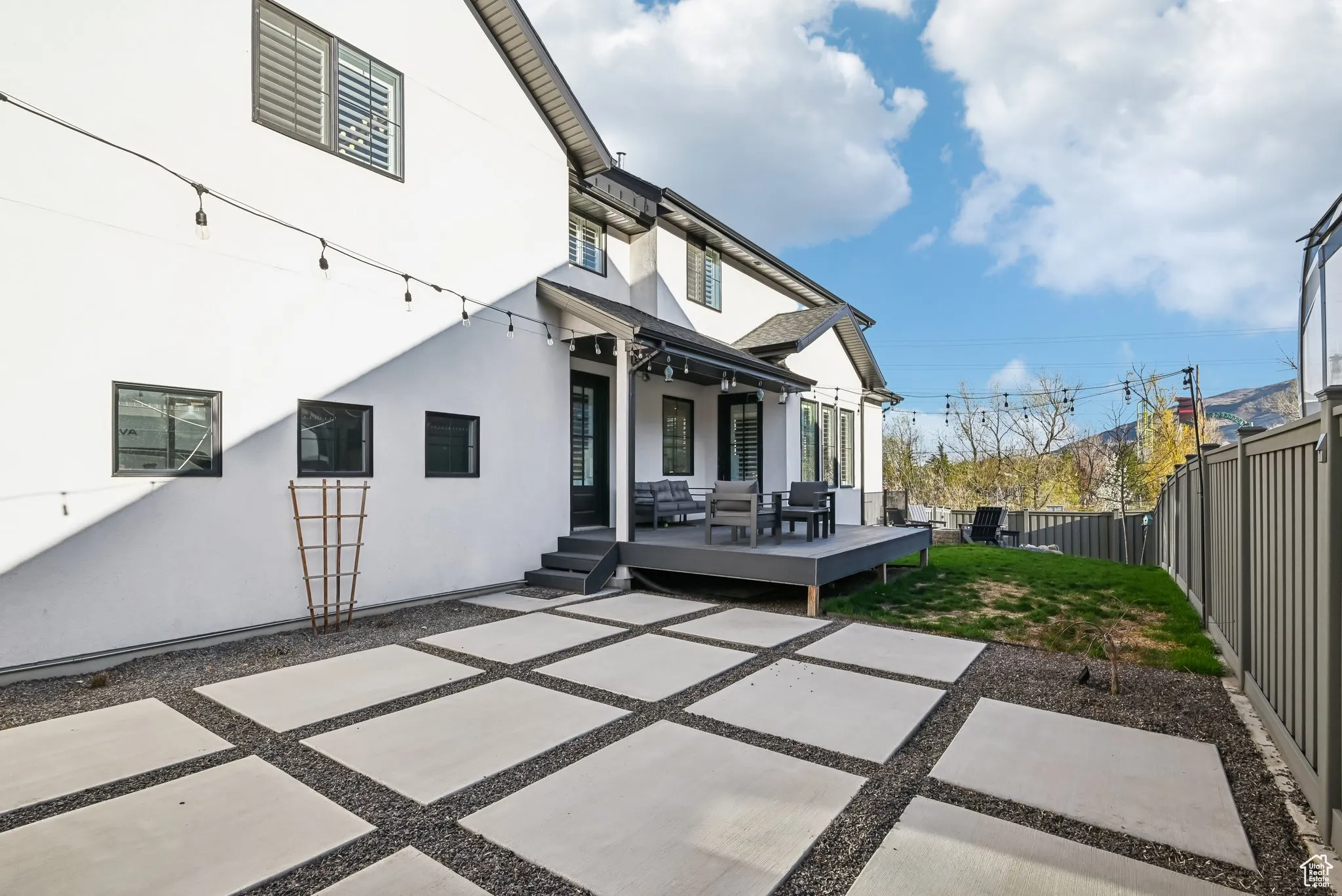 Rear view of property with a patio area, a fenced backyard, and stucco siding
