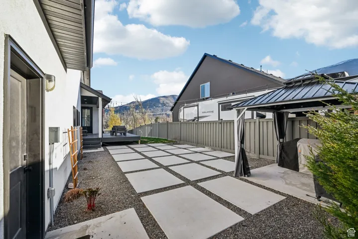 View of patio featuring fence, a gazebo, and a mountain view