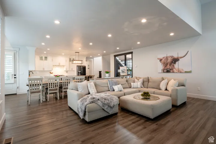 Living room featuring baseboards, visible vents, recessed lighting, and dark wood-style flooring