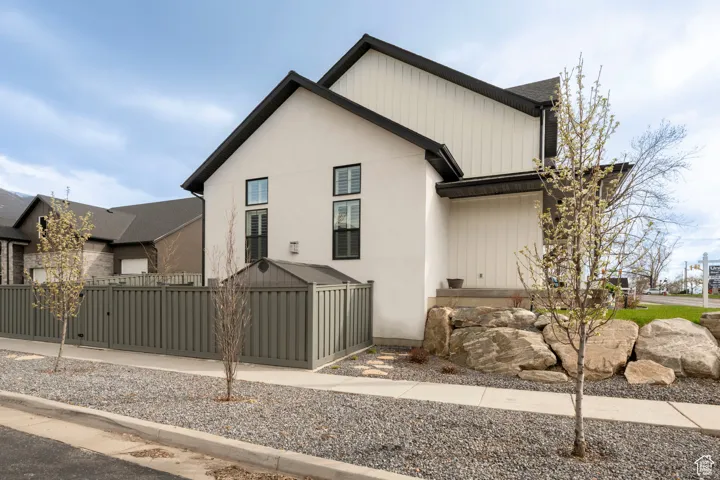 Modern farmhouse with a fenced front yard