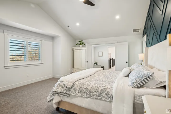 Bedroom with baseboards, recessed lighting, visible vents, lofted ceiling, and carpet