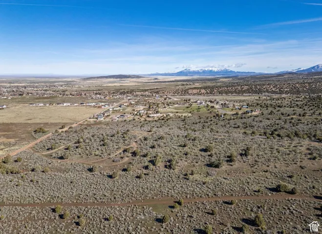Drone / aerial view featuring a mountain view and a desert view