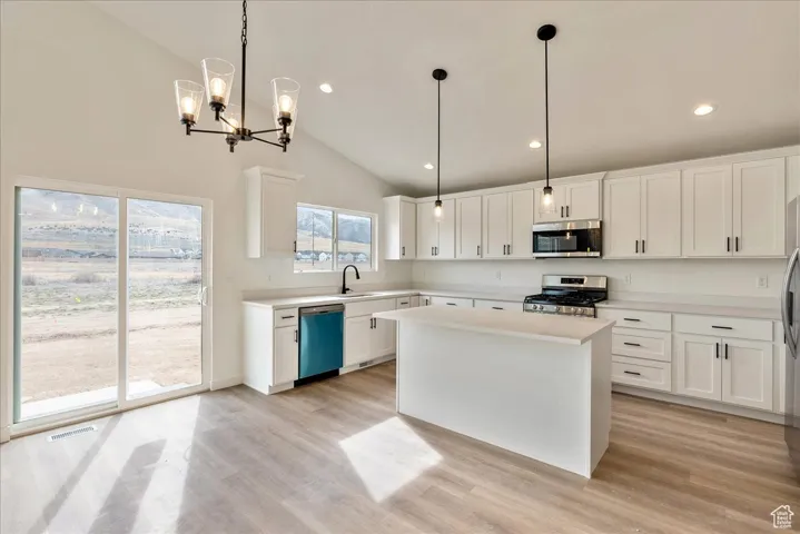 Kitchen featuring visible vents, light countertops, appliances with stainless steel finishes, and light wood finished floors