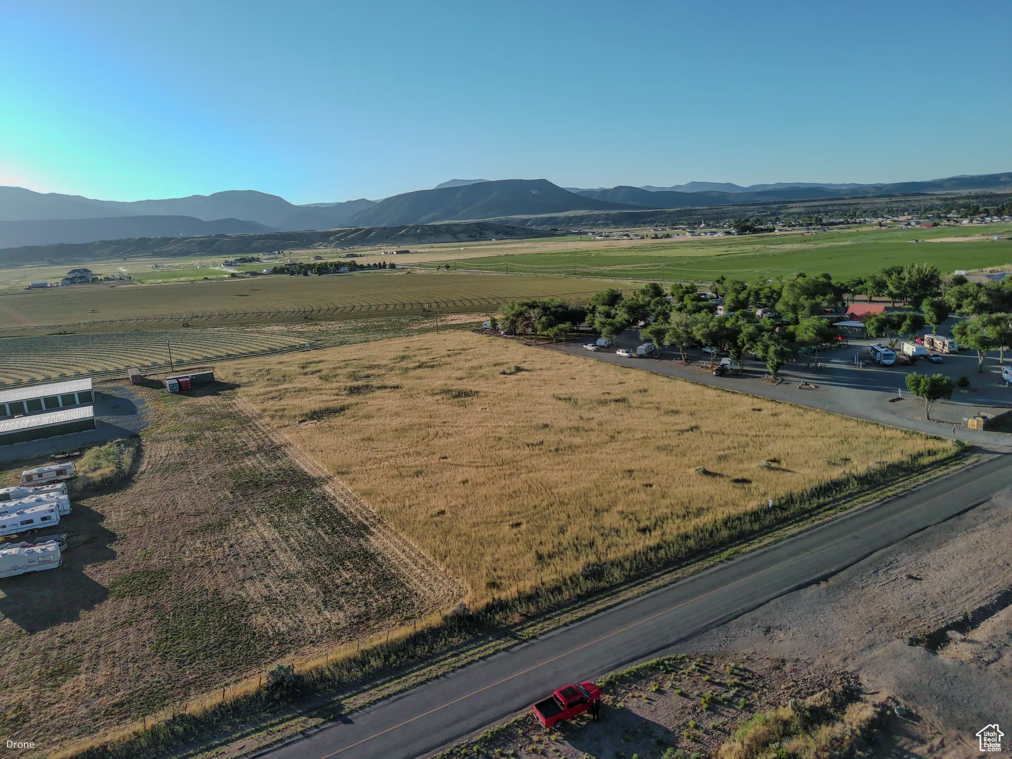 Aerial view of sparsely populated area with mountains and farmland