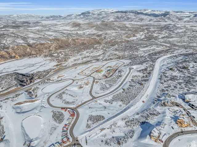 Snowy aerial view featuring a mountain view