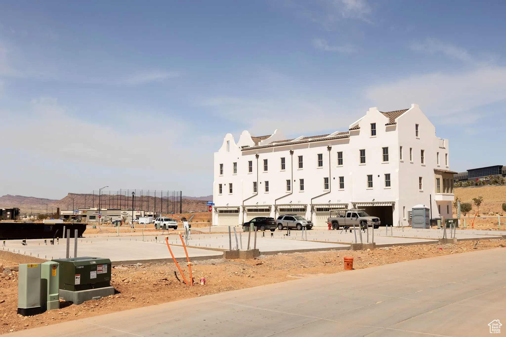 View of property with central AC unit and a garage