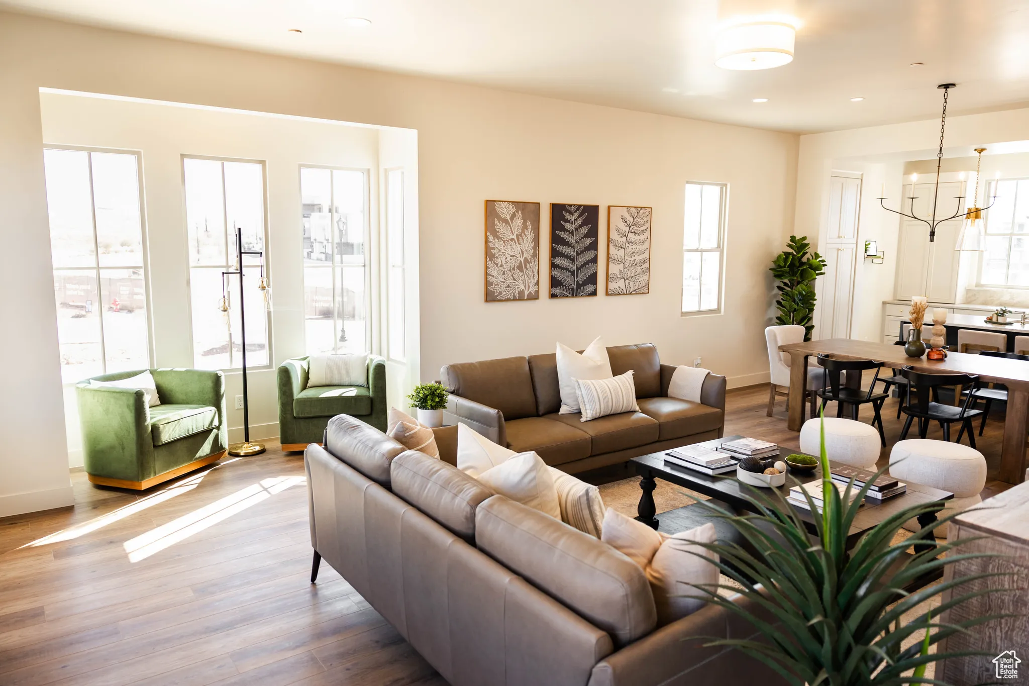 Living area featuring baseboards, recessed lighting, a chandelier, and wood finished floors