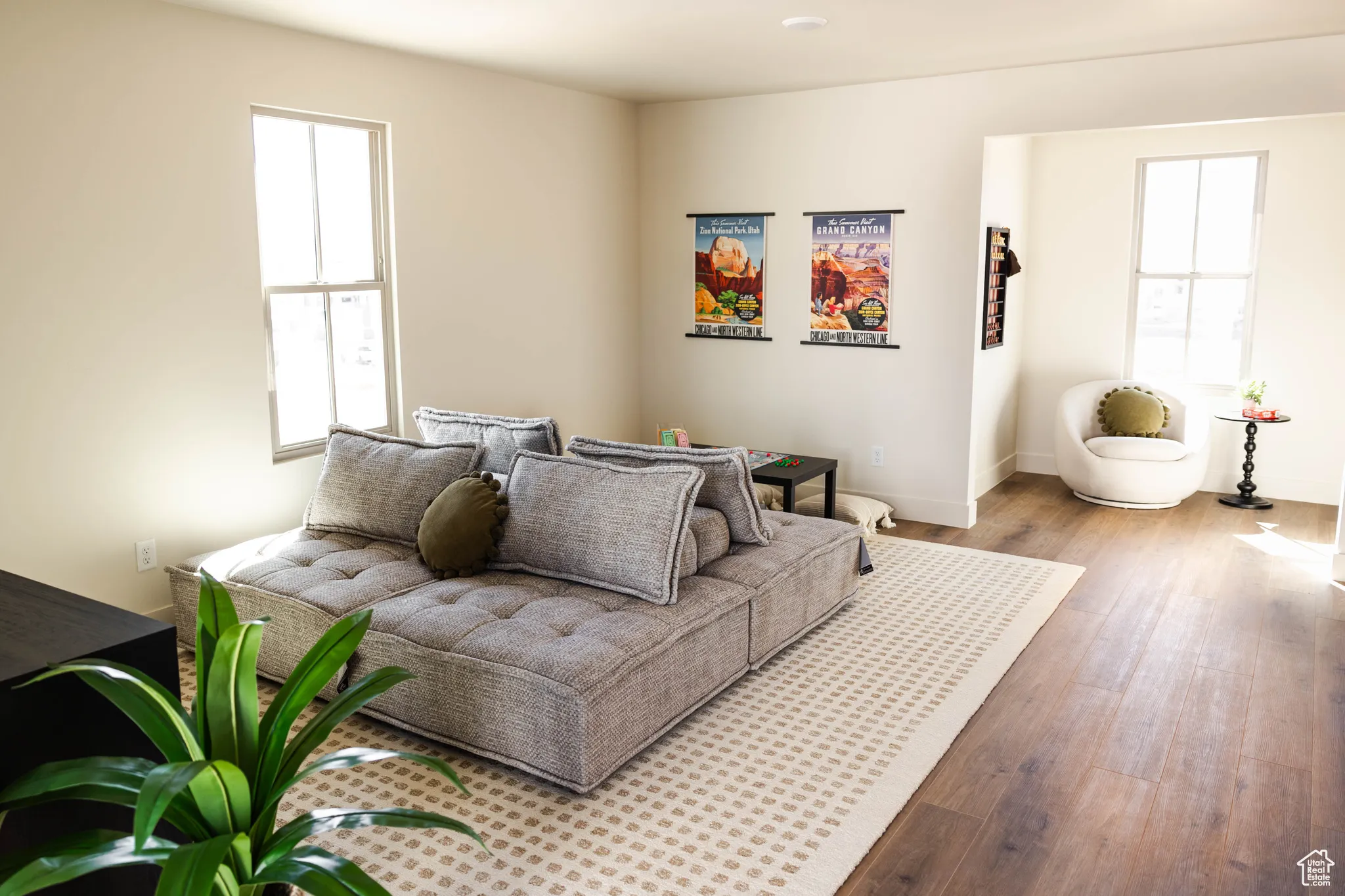 Living area with plenty of natural light and hardwood / wood-style floors