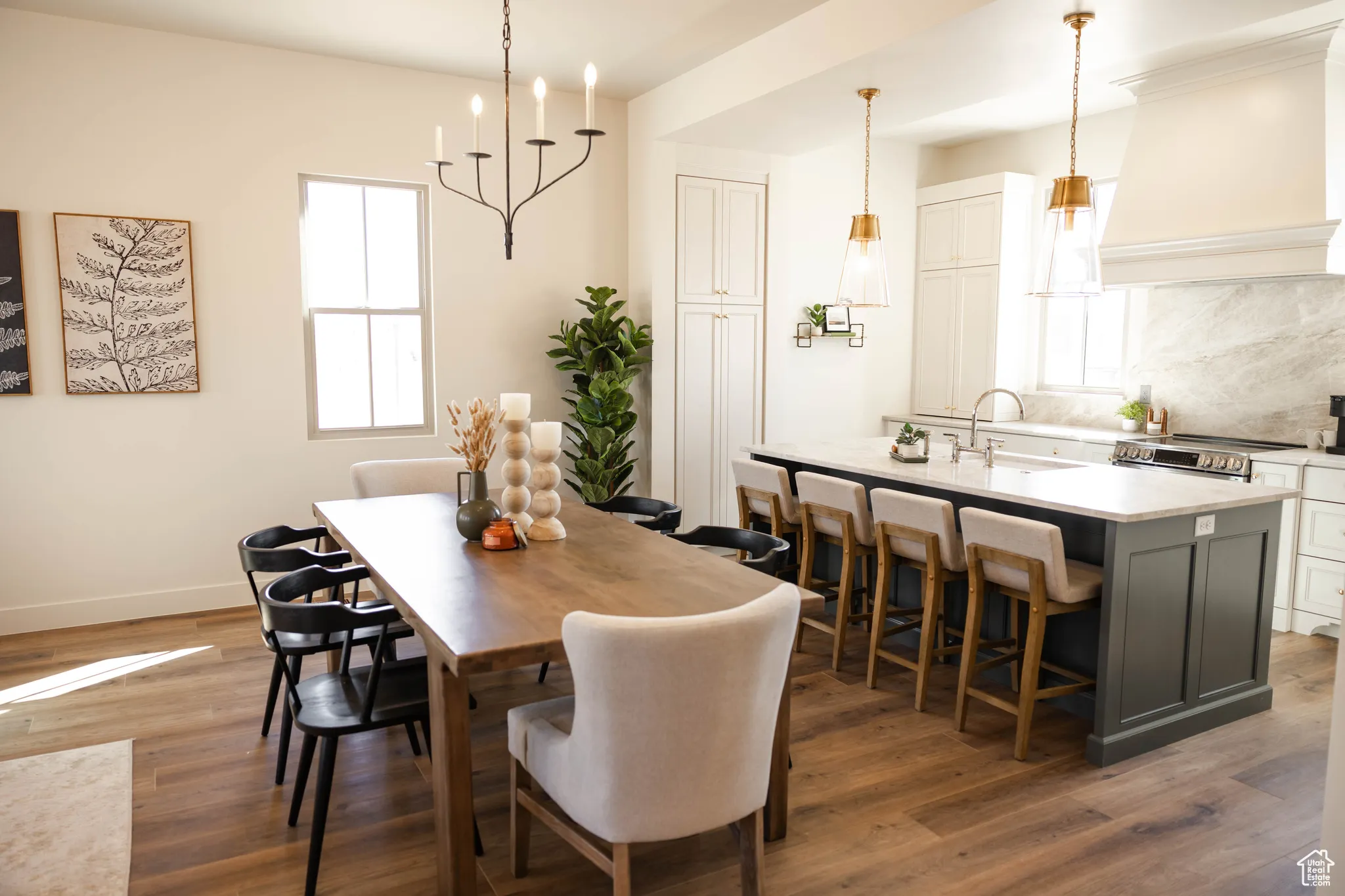 Dining space featuring baseboards, an inviting chandelier, and wood finished floors