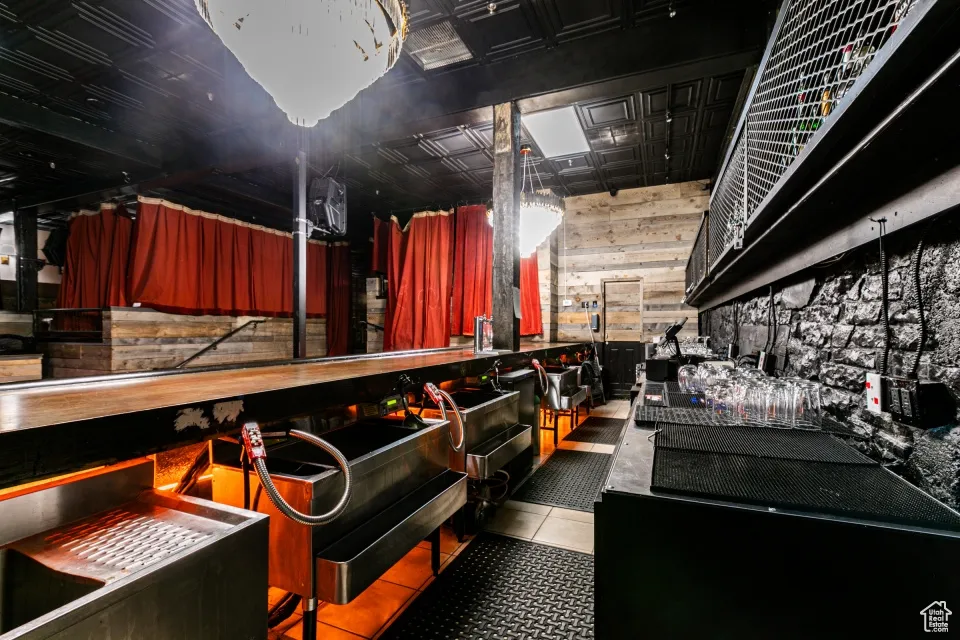 Misc room featuring tile patterned floors and wooden walls