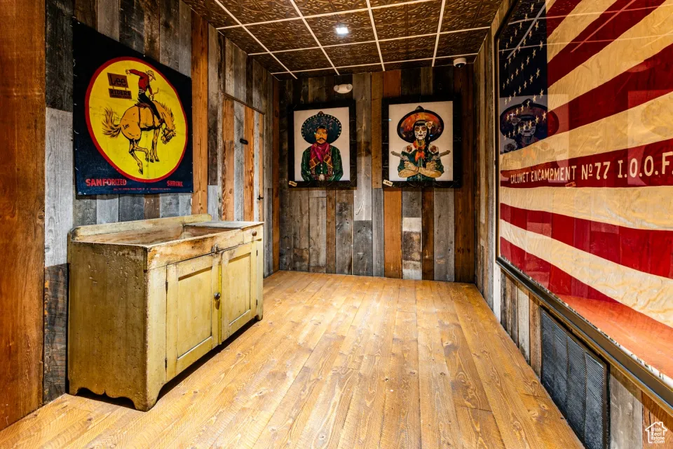 Interior space with wooden walls and hardwood / wood-style floors