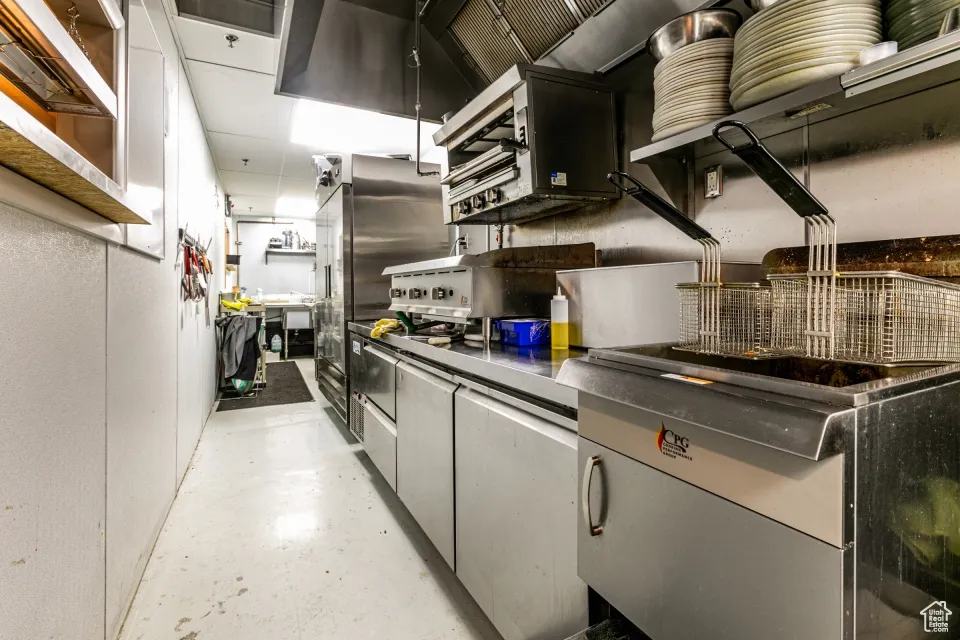 Kitchen with concrete flooring and open shelves