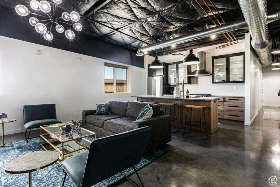 Living area featuring baseboards and finished concrete flooring