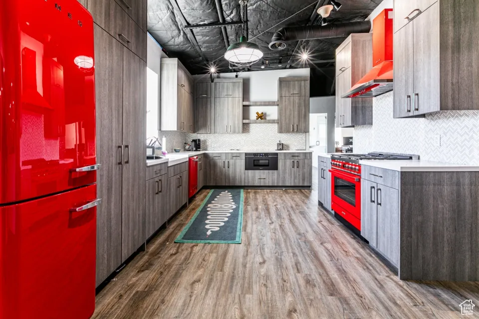 Kitchen with high end stainless steel range oven, wood finished floors, open shelves, and modern cabinets