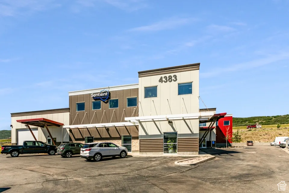 View of building exterior with uncovered parking