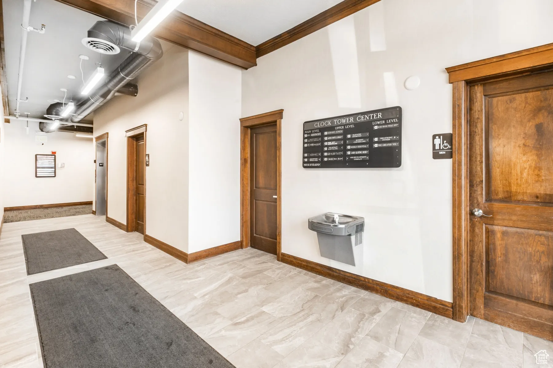 Hallway featuring visible vents and baseboards