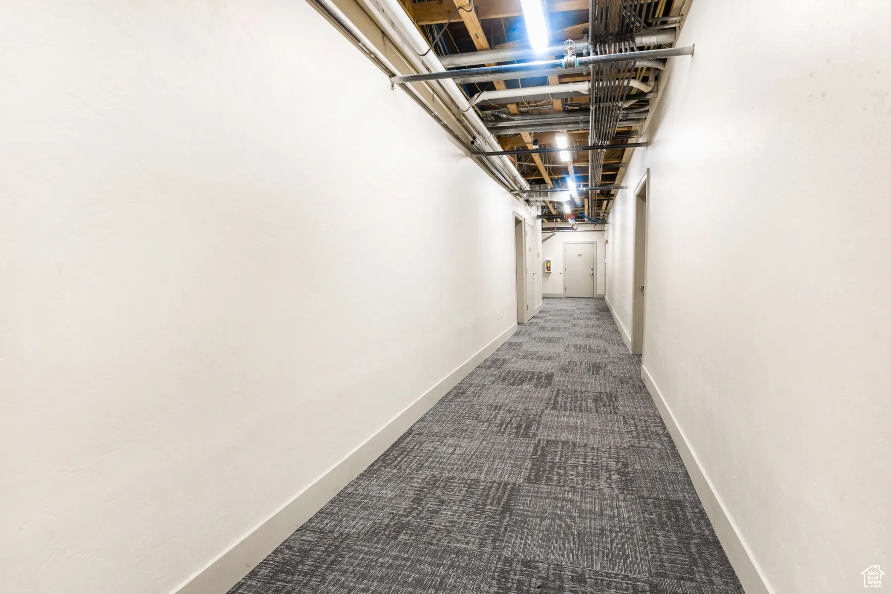 Hall featuring carpet flooring and baseboards