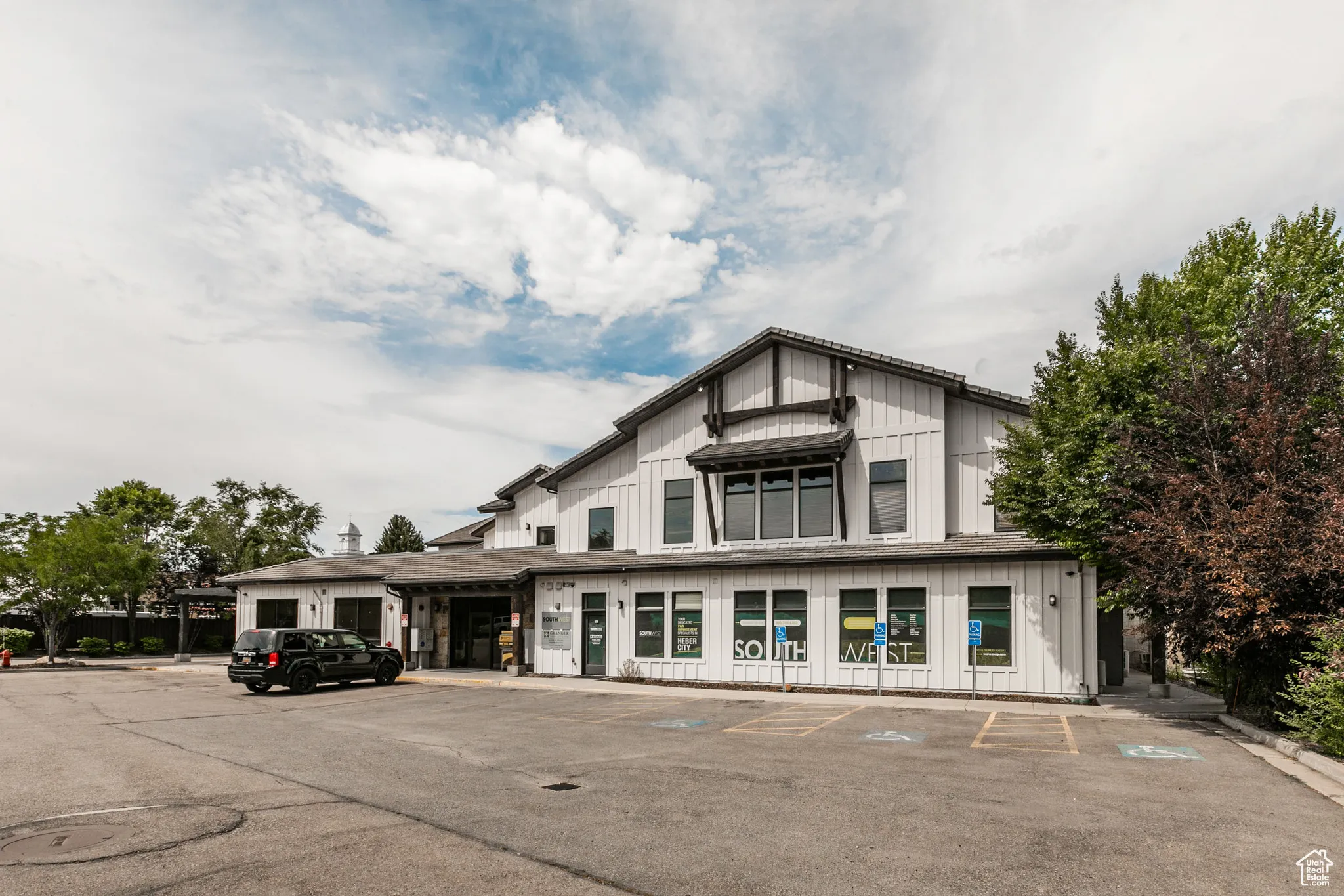 View of building exterior featuring uncovered parking