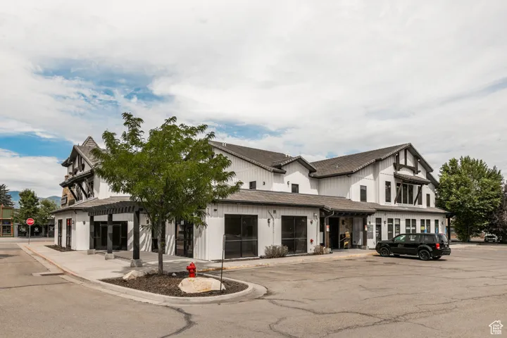 View of property with uncovered parking