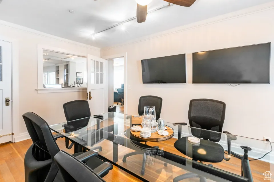 Office with ornamental molding, a ceiling fan, track lighting, and wood finished floors