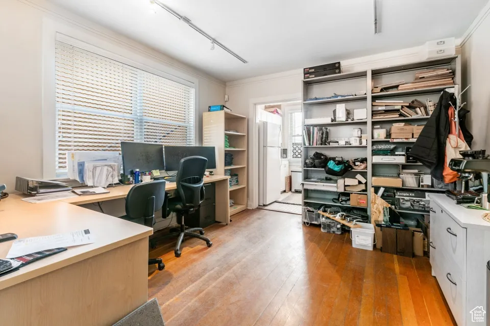 Office featuring track lighting and light wood finished floors