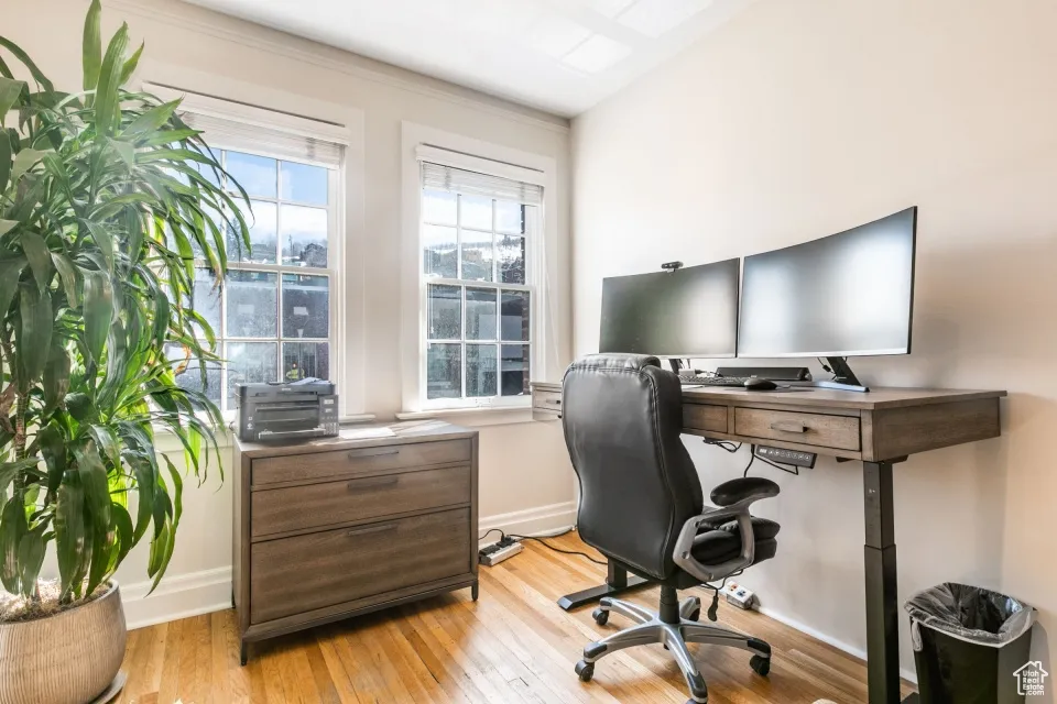 Home office featuring light wood finished floors and baseboards