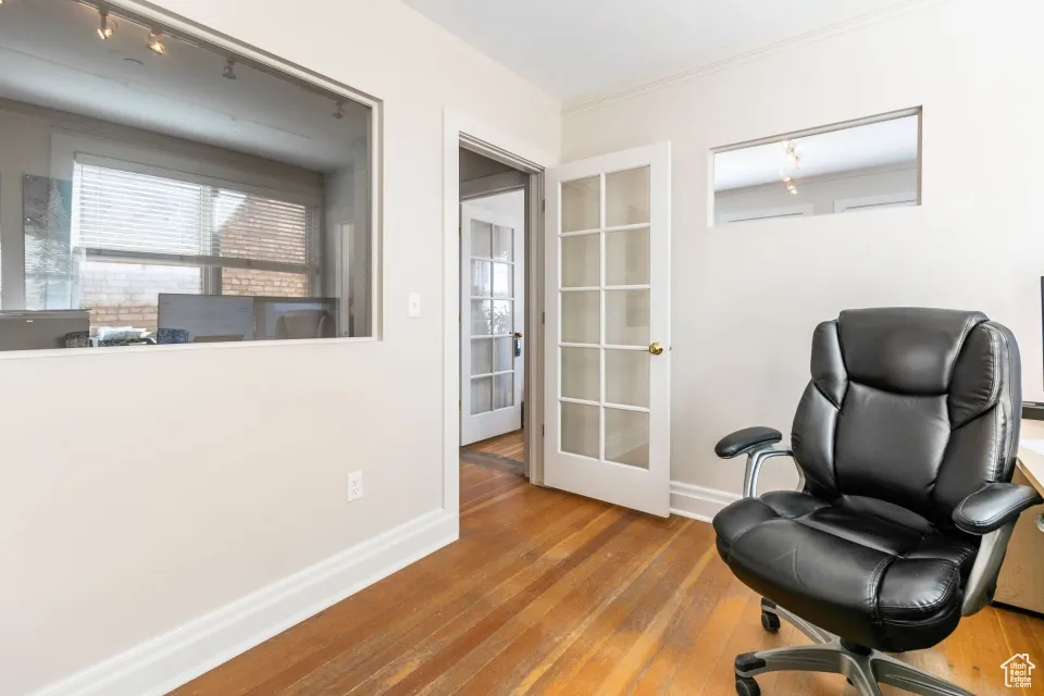Living area featuring wood-type flooring, french doors, baseboards, and track lighting