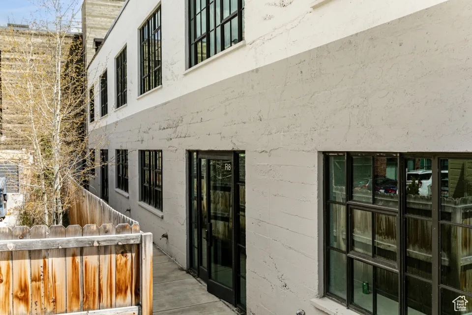 View of exterior entry featuring fence