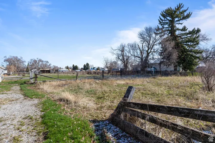 View of yard featuring fence and a rural view