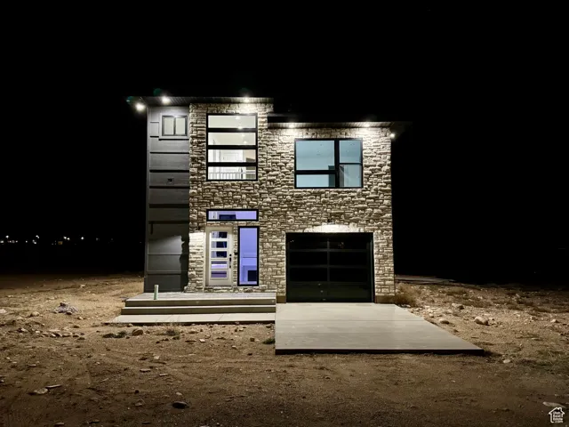 Modern home featuring stone siding