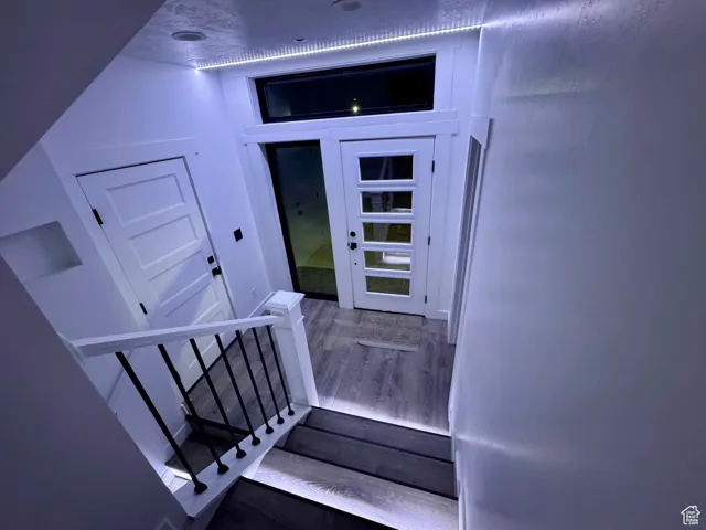 Stairs featuring wood finished floors