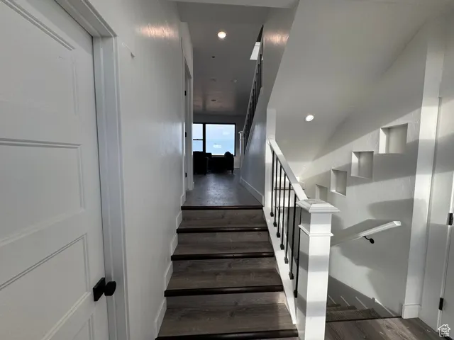 Stairs with recessed lighting, baseboards, and wood finished floors