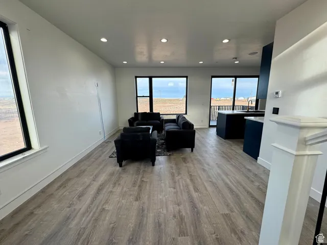 Living area featuring recessed lighting, baseboards, and wood finished floors