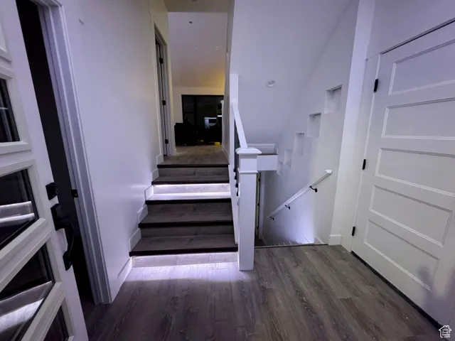 Staircase featuring wood finished floors