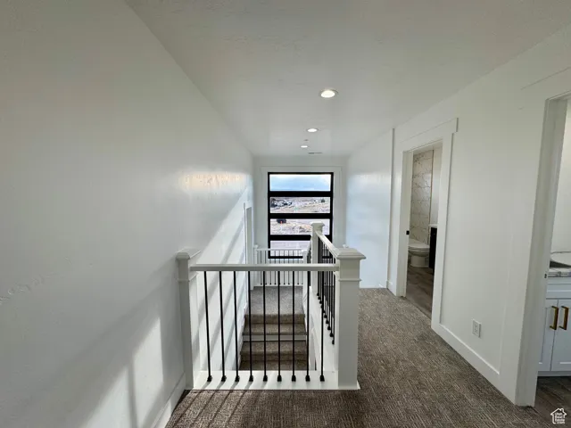 Stairway featuring recessed lighting, carpet flooring, and baseboards