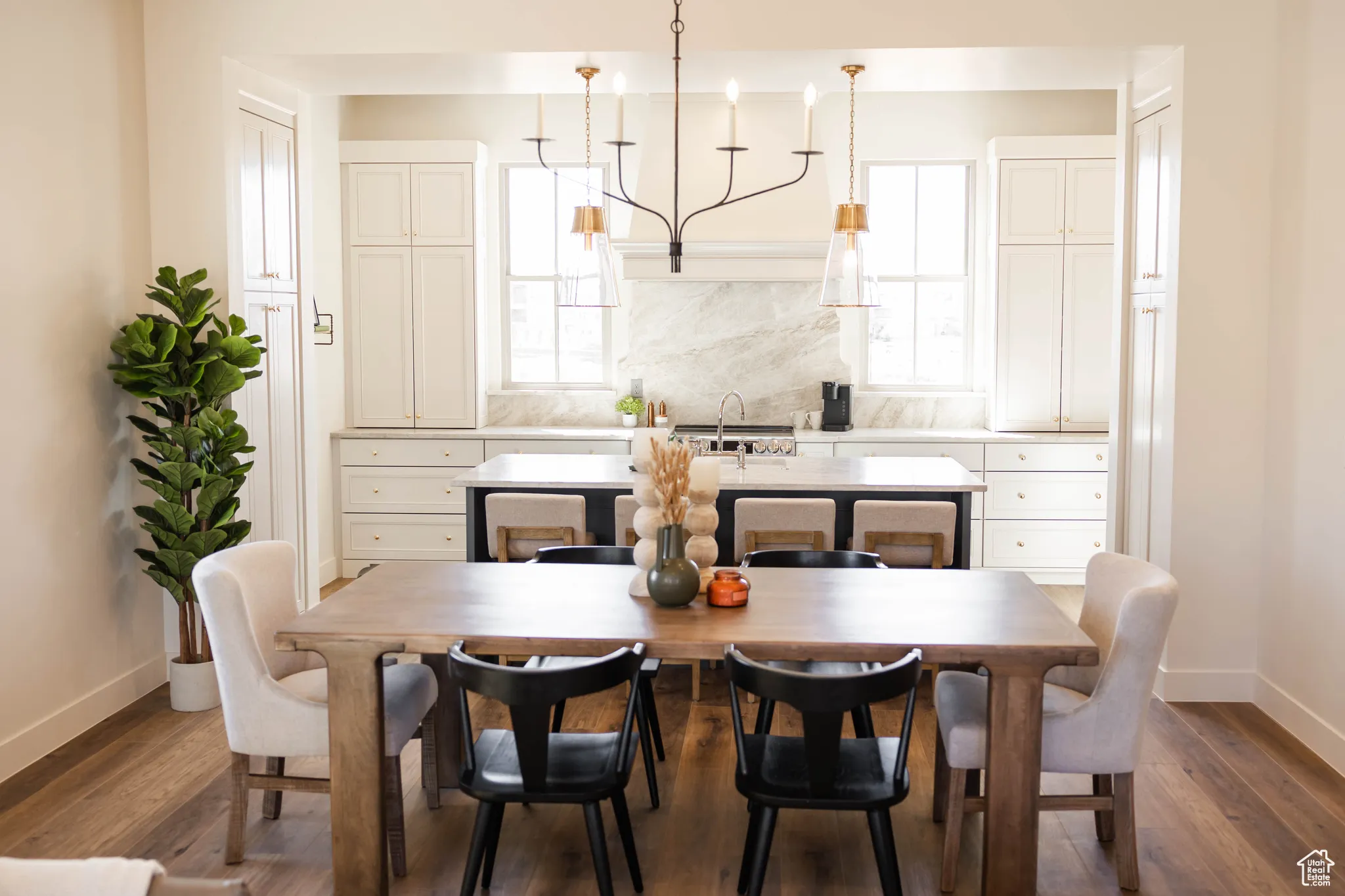 Dining space featuring a wealth of natural light, dark wood-style flooring, and baseboards