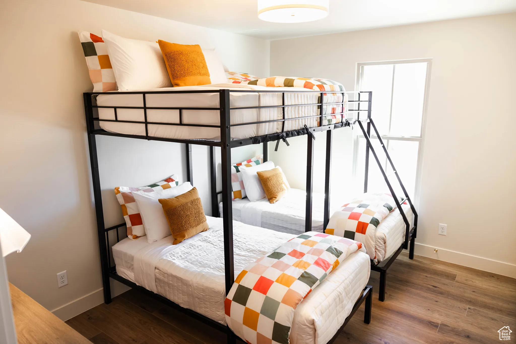 Bedroom featuring baseboards and wood finished floors