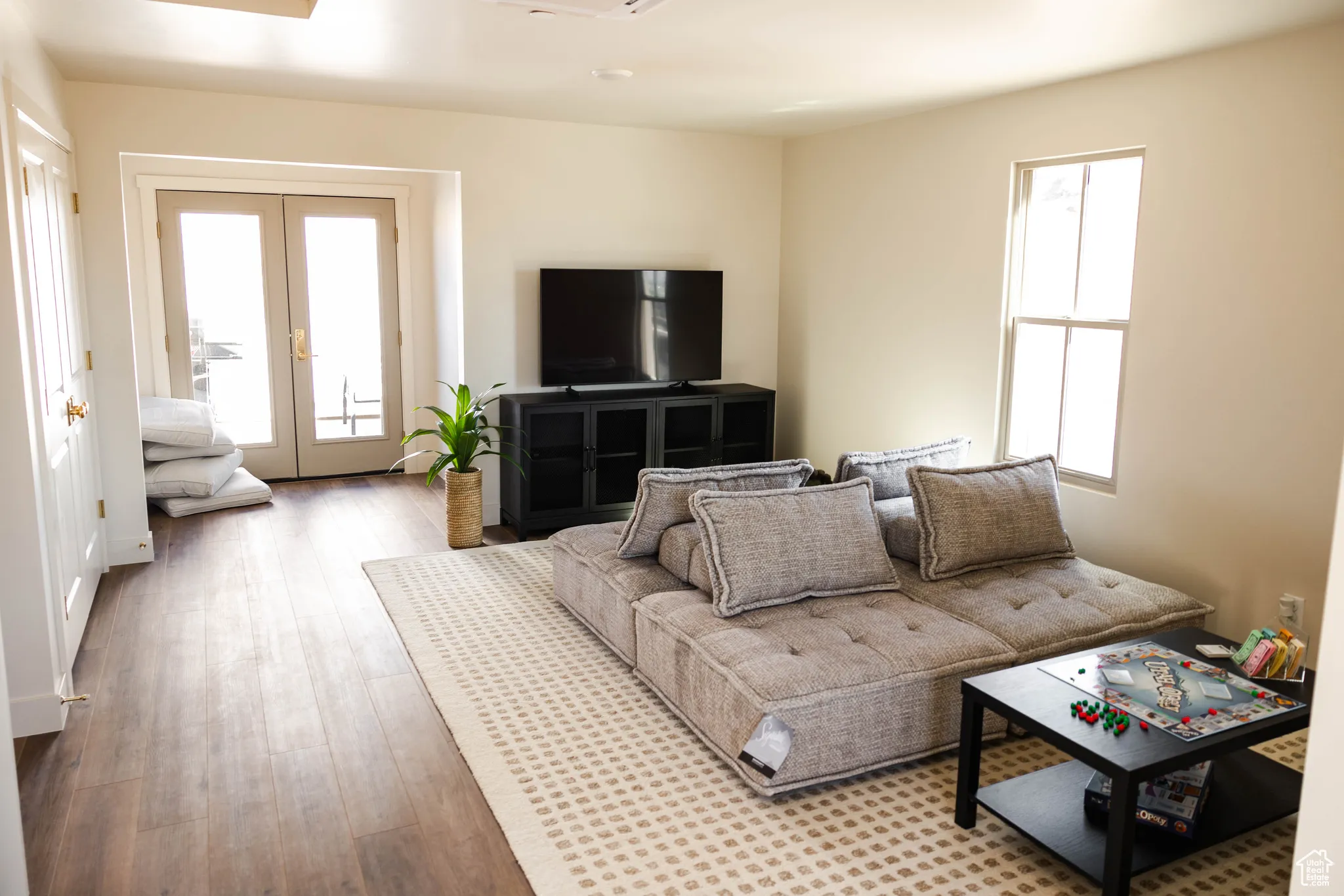 Living room with french doors and wood finished floors