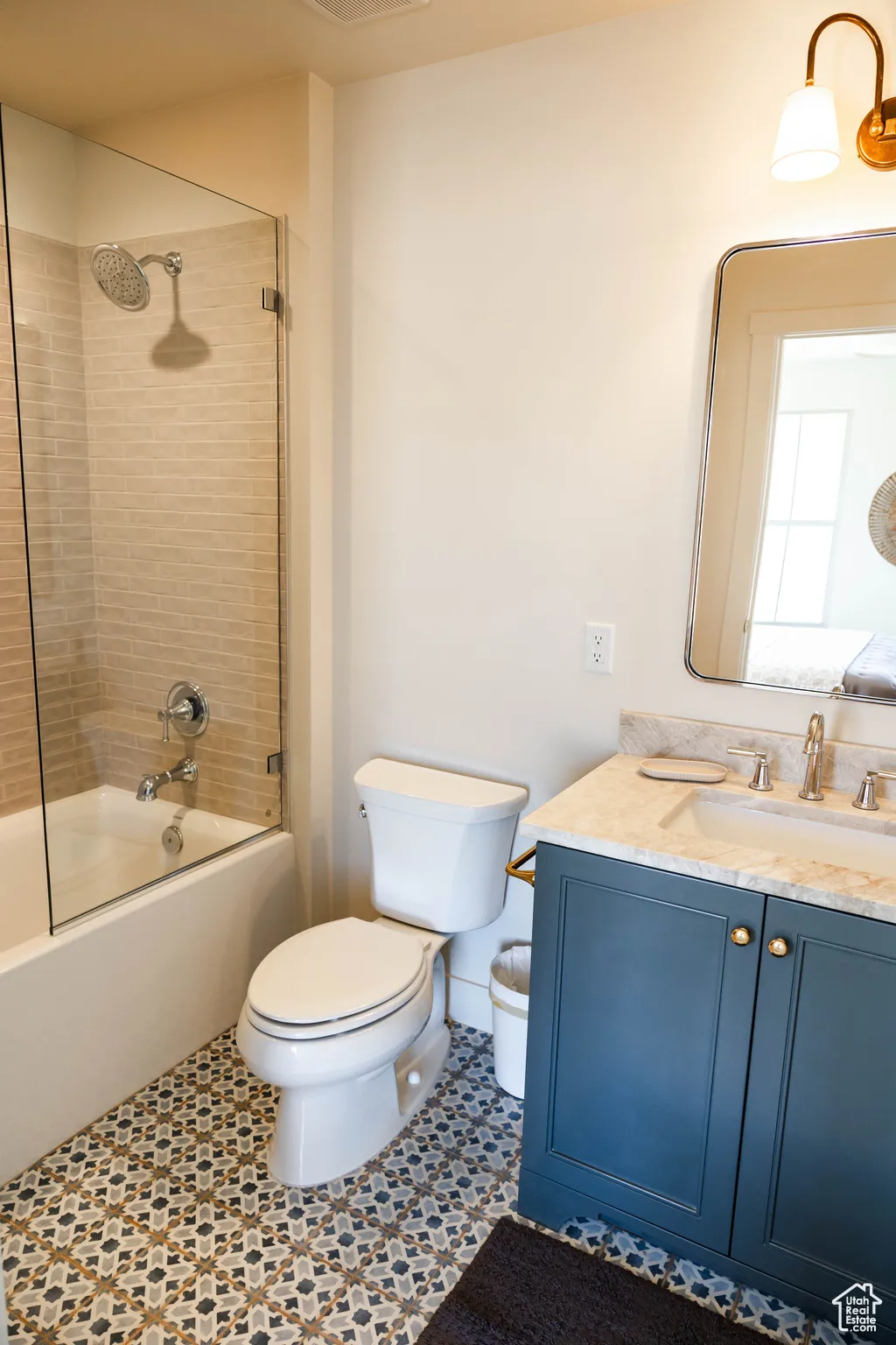 Full bathroom with  shower combination, vanity, visible vents, and toilet
