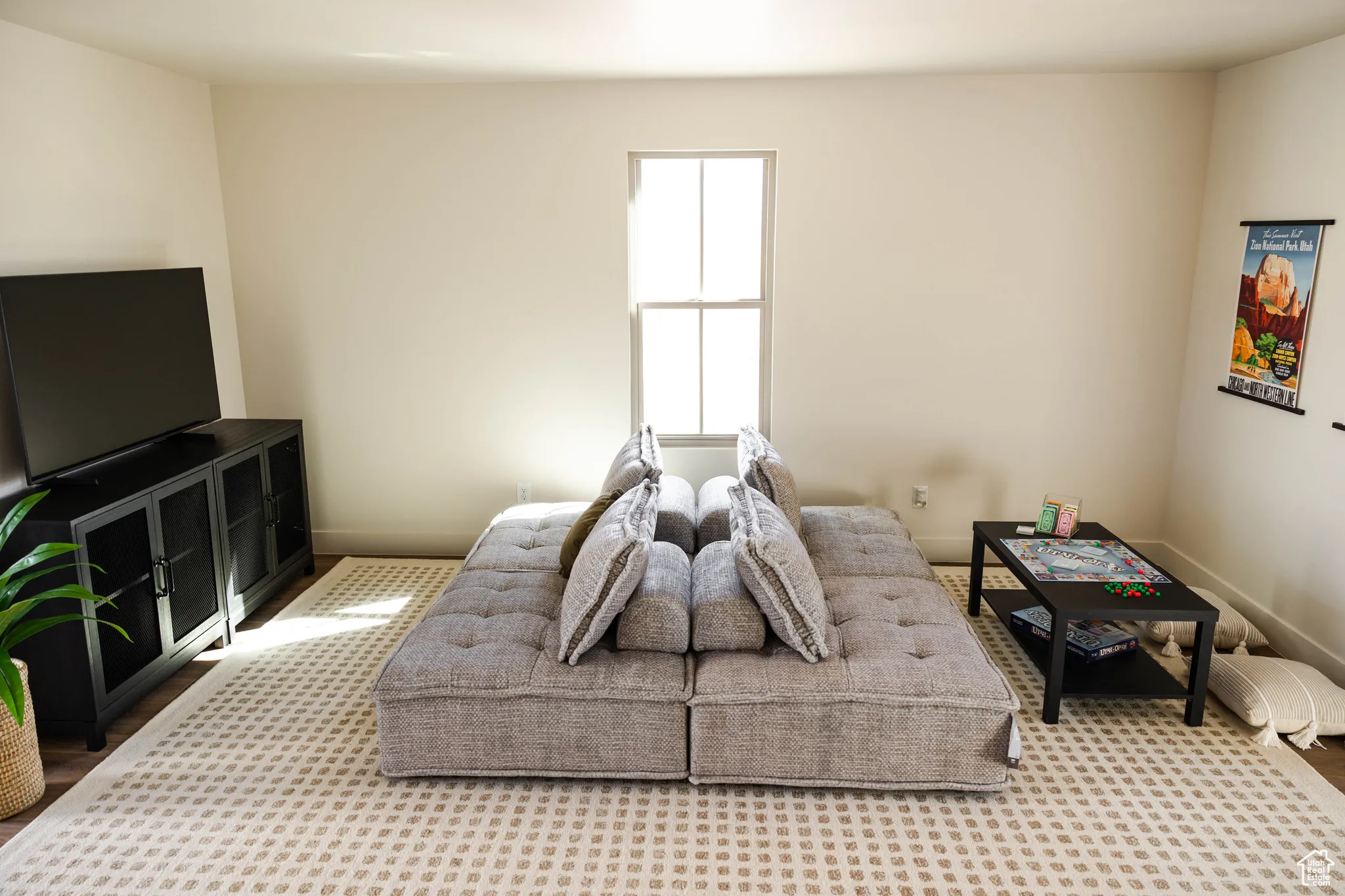 Living area with baseboards and carpet