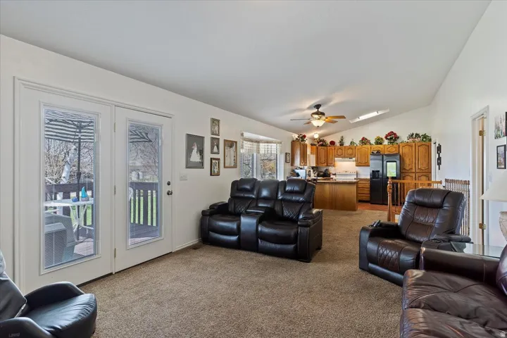 Living area with vaulted ceilings, recessed lighting, and a skylight