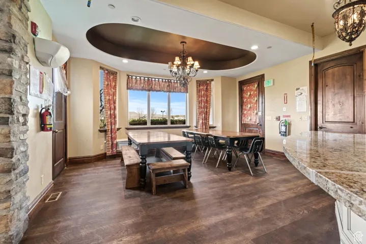 Dining room with visible vents, baseboards, an inviting chandelier, and dark wood finished floors